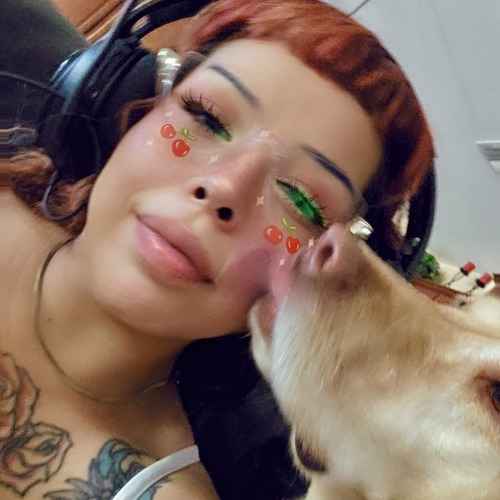 A FurBabies & Friends pet sitter receives a kiss from a tan-and-white dog during an in-home pet-sitting visit.