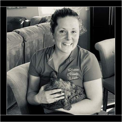 Trainer Kristie Halverson holding a new puppy that feel asleep during puppy training in Vistancia, AZ Trainer Kristie Halverson holding a new puppy that feel asleep during puppy training in Vistancia, AZ