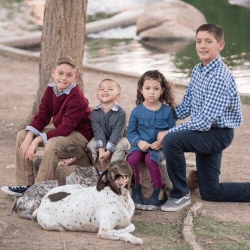 Furbabies & Friends 2022 Fall Family Photoshoot captured children and their German Shorthair Pointer during professional cute family photos in Glendale, AZ.