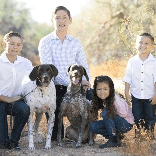 Furbabies & Friends 2022 Fall Family Photoshoot captured children and their two German Shorthair Pointers during professional cute family photos in Glendale, AZ.