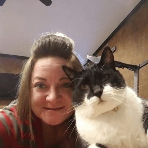Jo, a pet sitter for FurBabies & Friends in Glendale, AZ, poses with a cat sitting client during a drop in pet sitting visit.