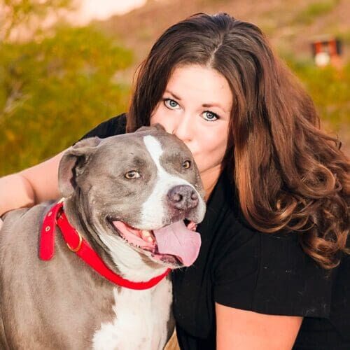 Positive reinforcement dog trainer, Kristie Halverson, owner of Furbabies & Friends and her grey XL bully Mix Baloo during a professional pet photography session.