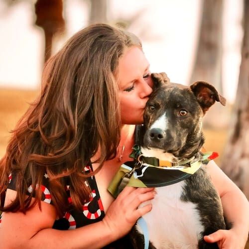 Positive reinforcement dog trainer, Kristie Halverson, owner of Furbabies & Friends and her brindled pitbull mix Tigger during a family photoshoot.