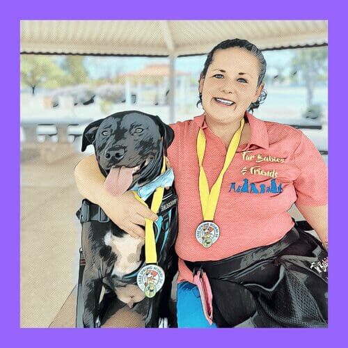 Kristie and her black pitbull Apollo pose for teh AKC Fit Dog Spring Scurry after walk celebration in Glendale, AZ.