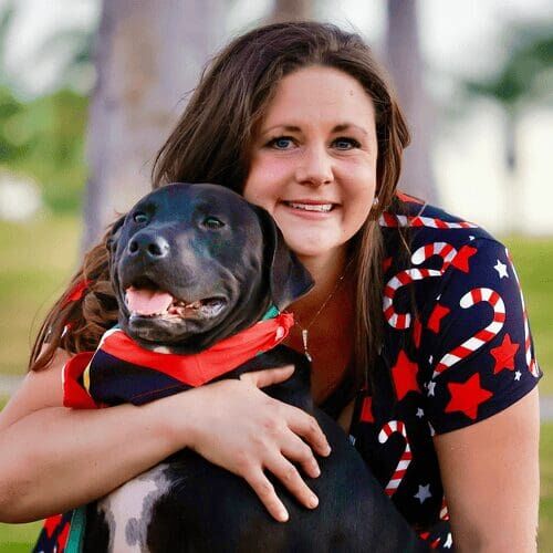 Positive reinforcement dog trainer, Kristie Halverson, owner of Furbabies & Friends and her black pitbull Apollo.