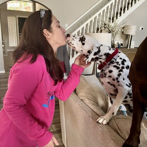 FurBabies & Friends dog walker Sandra getting kisses from a Dalmatian before a dog walk in Glendale AZ