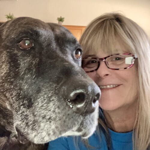 Happy overnight pet sitter smiling with a black Great Dane in Phoenix AZ
