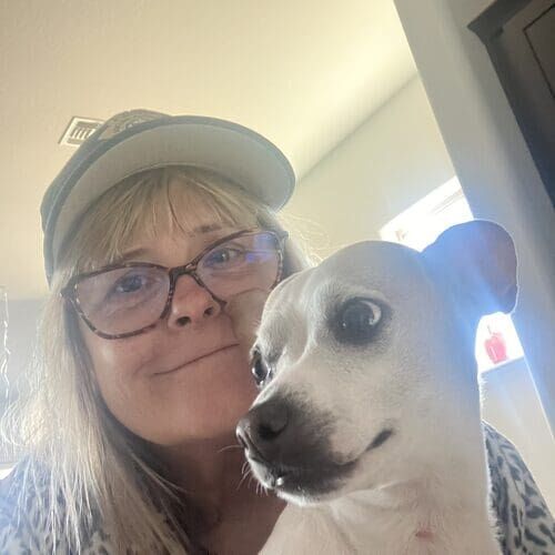 Michelle from FurBabies & Friends smiling with a small white dog during overnight pet sitting in Vistancia AZ