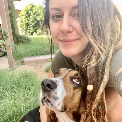 Pet sitter Brittany from FurBabies & Friends hugging a Basset Hound in Glendale AZ