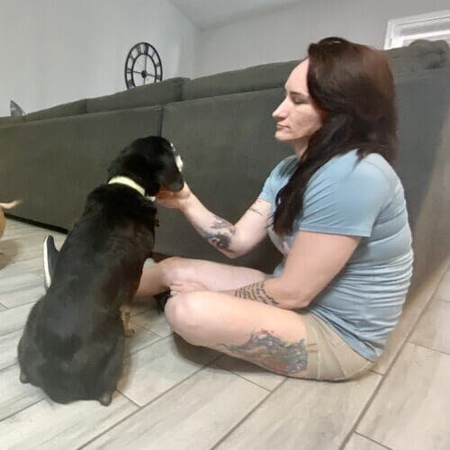 Pet sitter Melissa petting a senior dog during a pet care visit in Glendale AZ