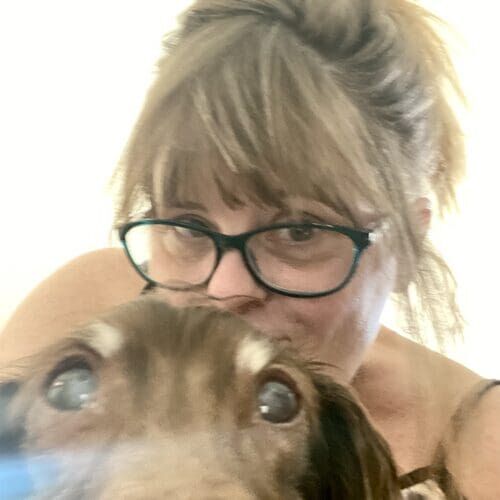 Pet sitter Michelle kissing a Dachshund on the head during 24-hour live-in pet sitting in Phoenix AZ
