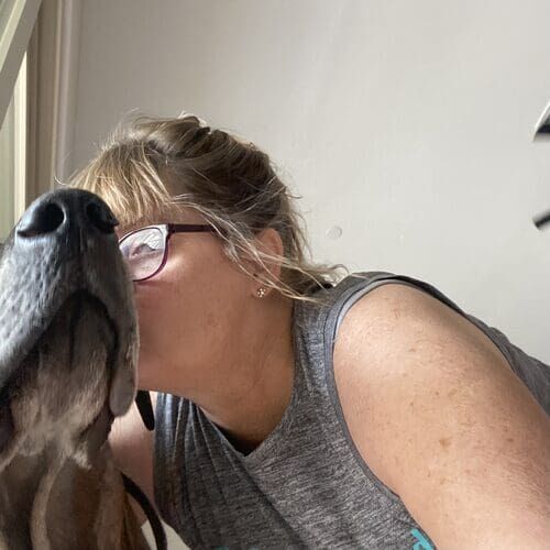 Pet sitter Michelle kissing a dog during overnight pet sitting in Glendale AZ