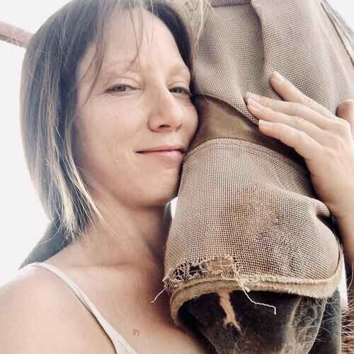 Pet sitter Sandra hugging a horse during horse care services in Glendale AZ