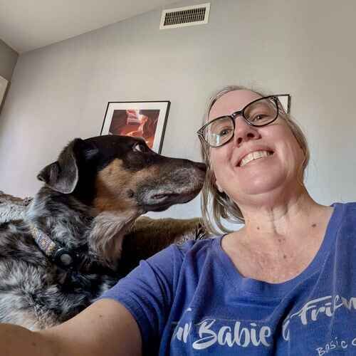 Pet sitter Karen gets kisses from rescue dog Bert during pet sitting in Arrowhead Ranch, AZ