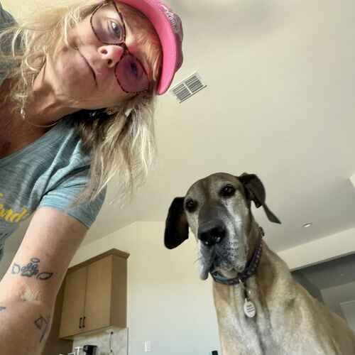 Dog sitter Michelle poses with Great Dane Hattie during overnight pet sitting in Surprise, AZ