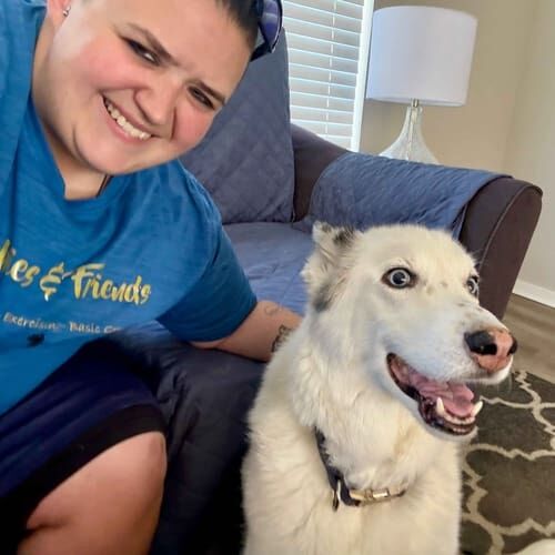 Dog sitter Vanessa with senior white Husky Loki during a midday potty break in Glendale, AZ