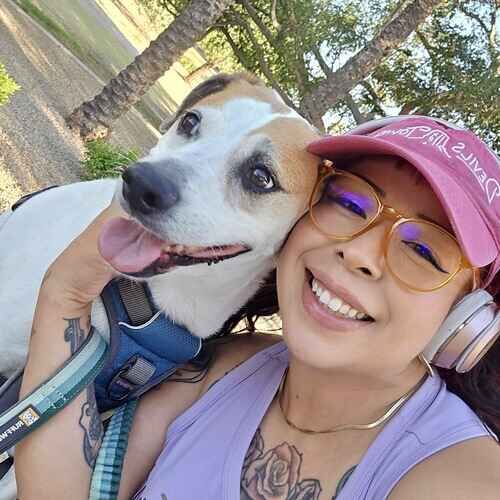Rescue dog Coco poses with dog walker Nina during a morning walk in Glendale, AZ